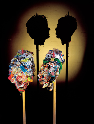Illustration for article titled Gruesome shadow art transforms garbage and mummified rats into severed heads